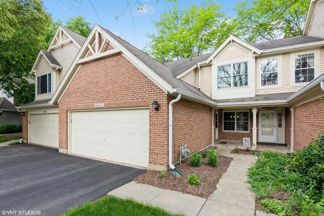 30W012 Laurel Ct, Warrenville, IL 60555 - view of front of property featuring driveway, brick siding, a garage, and a porch