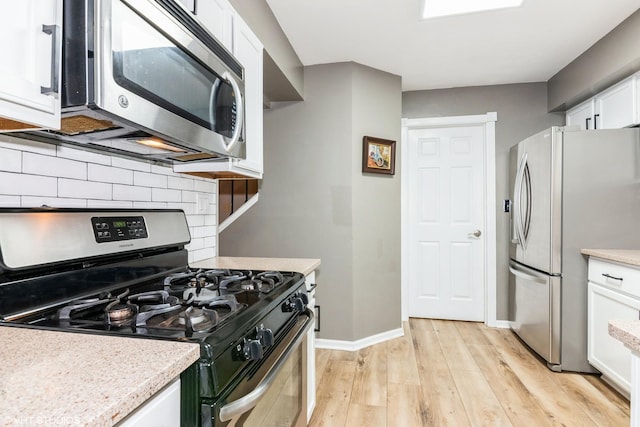 30W012 Laurel Ct, Warrenville, IL 60555 - kitchen with appliances with stainless steel finishes, decorative backsplash, white cabinets, and light countertops