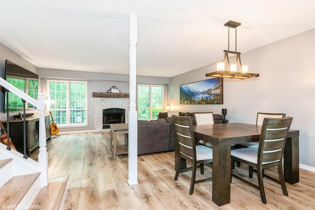 30W012 Laurel Ct, Warrenville, IL 60555 - dining space with light wood-type flooring, a fireplace, and stairway