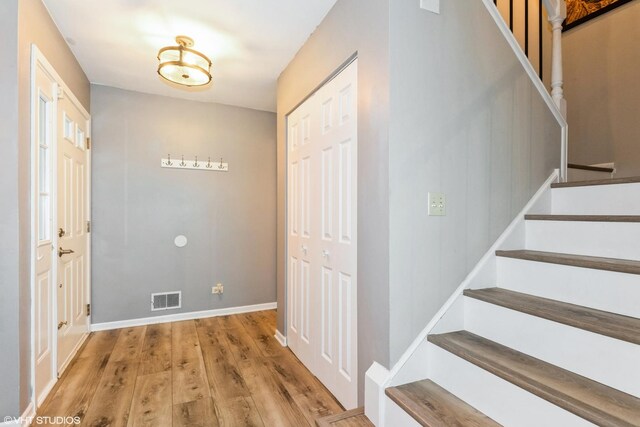 30W012 Laurel Ct, Warrenville, IL 60555 - foyer featuring stairway, wood finished floors, and baseboards