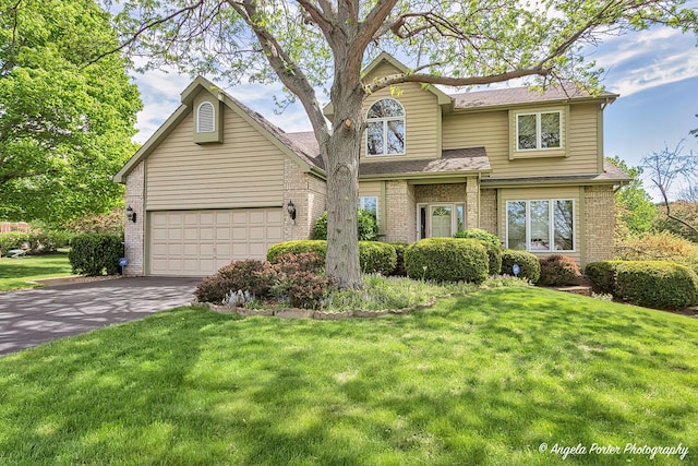 8720 Galleria Ct, Spring Grove, IL 60081 - traditional-style house with driveway, brick siding, a shingled roof, and a garage