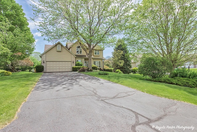 8720 Galleria Ct, Spring Grove, IL 60081 - view of front facade with asphalt driveway, a front lawn, and a garage