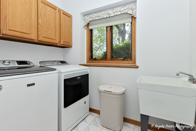 8720 Galleria Ct, Spring Grove, IL 60081 - laundry area featuring cabinet space, washer and clothes dryer, baseboards, and light marble finish floors