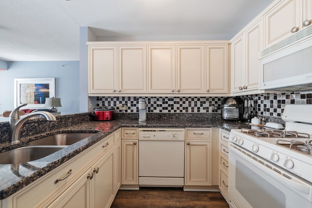 400 Village Cir Unit 207, Willow Springs, IL 60480 - kitchen featuring white appliances, cream cabinetry, a sink, decorative backsplash, and dark stone counters