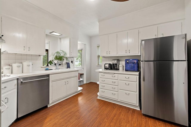409 Cottage Ave, Glen Ellyn, IL 60137 - kitchen featuring appliances with stainless steel finishes, white cabinetry, decorative backsplash, and light countertops