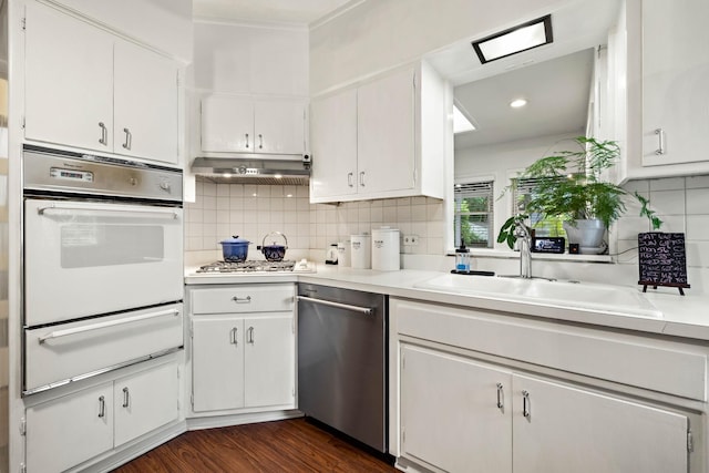 409 Cottage Ave, Glen Ellyn, IL 60137 - kitchen featuring stainless steel appliances, a warming drawer, a sink, light countertops, and decorative backsplash