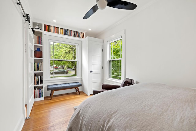 409 Cottage Ave, Glen Ellyn, IL 60137 - bedroom with crown molding, wood finished floors, a barn door, and a ceiling fan