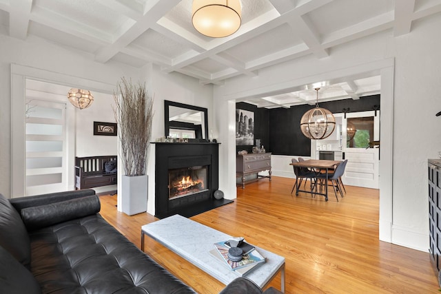 409 Cottage Ave, Glen Ellyn, IL 60137 - living area featuring a chandelier, coffered ceiling, light wood-style flooring, beamed ceiling, and a glass covered fireplace