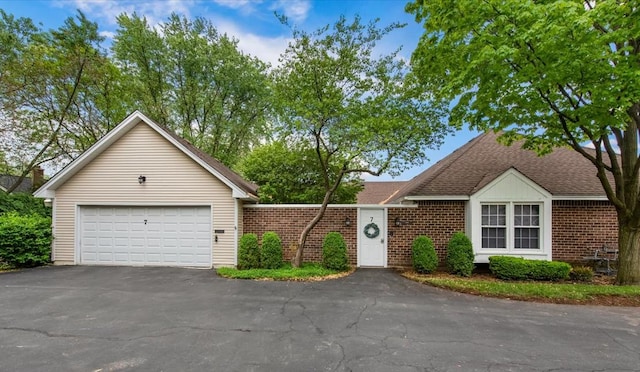7 Hampton On Auburn Dr, Rolling Meadows, IL 60008 - view of front facade with driveway, brick siding, and a shingled roof