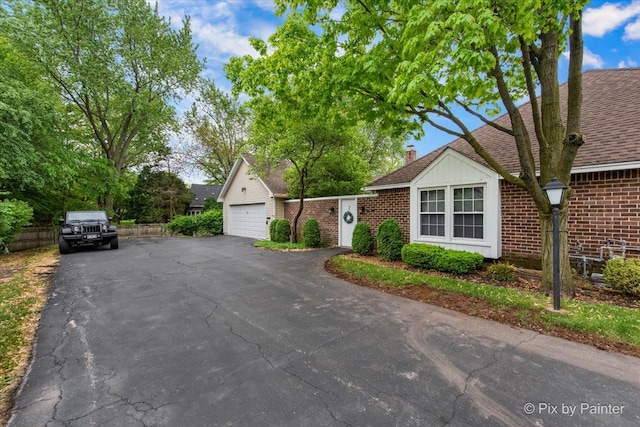 7 Hampton On Auburn Dr, Rolling Meadows, IL 60008 - view of front of home with brick siding, a garage, a chimney, and a shingled roof