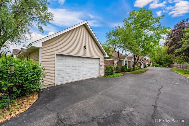 7 Hampton On Auburn Dr, Rolling Meadows, IL 60008 - view of side of home featuring a garage and asphalt driveway
