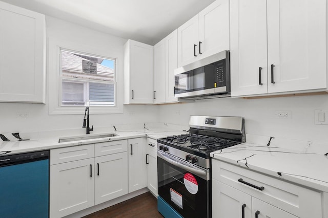 2519 N New England Ave, Chicago, IL 60707 - kitchen featuring appliances with stainless steel finishes, a sink, white cabinetry, light stone counters, and dark wood-type flooring