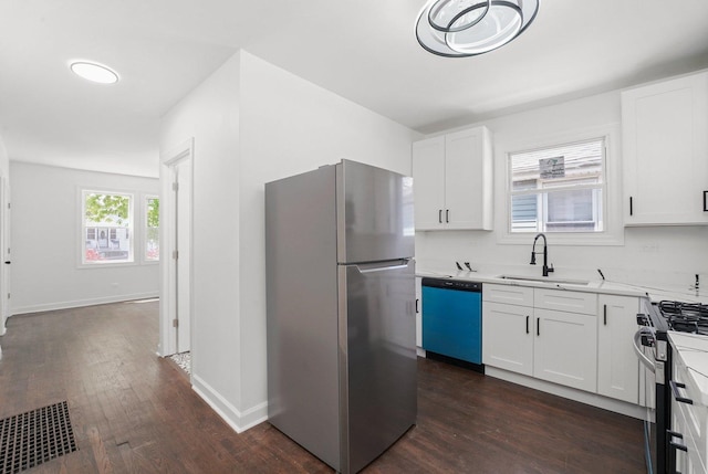 2519 N New England Ave, Chicago, IL 60707 - kitchen featuring appliances with stainless steel finishes, a sink, dark wood-style floors, and white cabinets