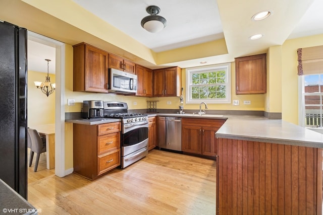 846 Dunhill Dr, Buffalo Grove, IL 60089 - kitchen with stainless steel appliances, a peninsula, healthy amount of natural light, brown cabinets, and recessed lighting