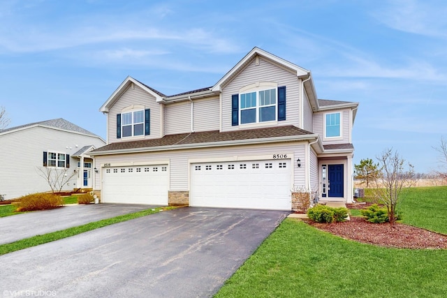 8506 Redbud Ct, Wonder Lake, IL 60097 - view of front of property with driveway, an attached garage, and a front yard