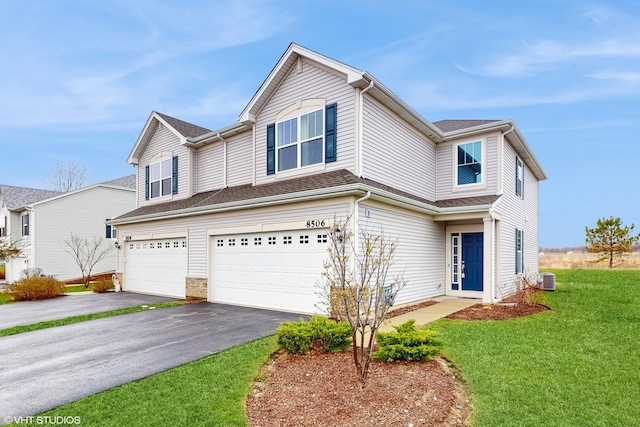 8506 Redbud Ct, Wonder Lake, IL 60097 - view of front facade featuring a garage, driveway, a front yard, and central AC unit