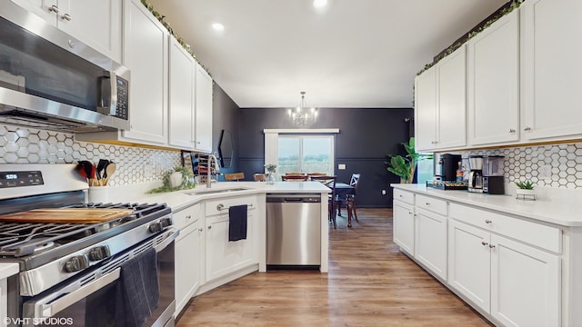 8506 Redbud Ct, Wonder Lake, IL 60097 - kitchen featuring stainless steel appliances, a sink, light countertops, white cabinetry, and recessed lighting
