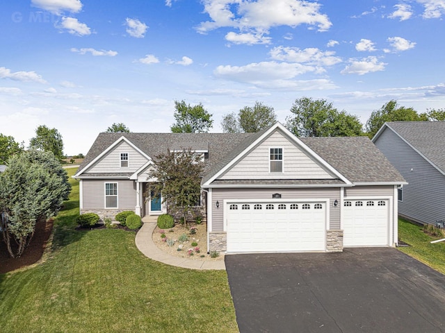 49 W Crabapple Ave, Cortland, IL 60112 - view of front of home featuring stone siding, asphalt driveway, a front yard, and an attached garage