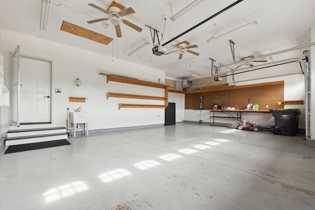 49 W Crabapple Ave, Cortland, IL 60112 - garage featuring a ceiling fan, a workshop area, and a garage door opener