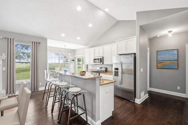 49 W Crabapple Ave, Cortland, IL 60112 - kitchen with appliances with stainless steel finishes, a kitchen island, dark wood finished floors, light stone countertops, and recessed lighting