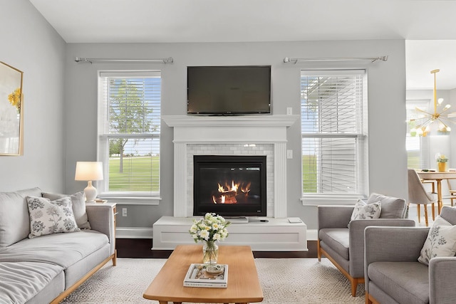 49 W Crabapple Ave, Cortland, IL 60112 - living room featuring wood finished floors, baseboards, healthy amount of natural light, and a glass covered fireplace