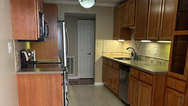 828 Graceland Ave Unit 206, Des Plaines, IL 60016 - kitchen featuring a sink, appliances with stainless steel finishes, tasteful backsplash, brown cabinetry, and crown molding