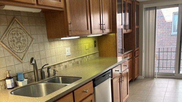 828 Graceland Ave Unit 206, Des Plaines, IL 60016 - kitchen with dishwasher, a sink, backsplash, brown cabinets, and light tile patterned floors