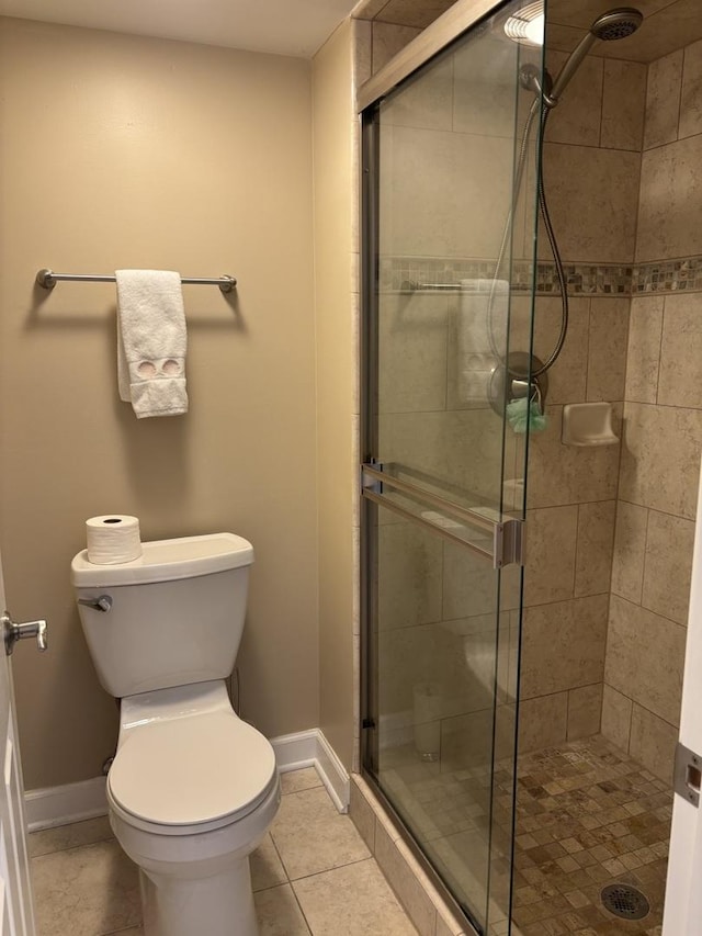 828 Graceland Ave Unit 206, Des Plaines, IL 60016 - bathroom featuring a stall shower, toilet, baseboards, and tile patterned floors