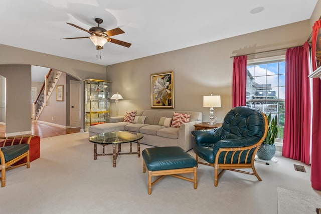 4804 Westborough Dr, Champaign, IL 61822 - living area featuring arched walkways, a ceiling fan, stairs, and baseboards