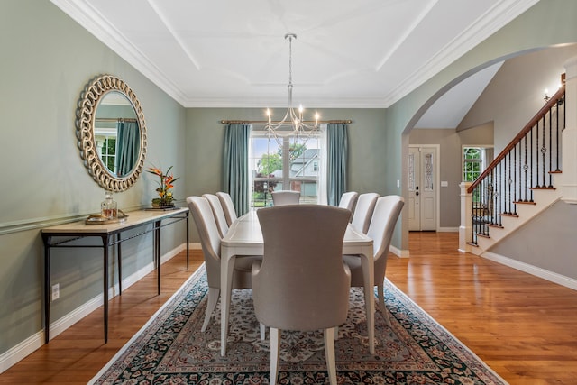 4804 Westborough Dr, Champaign, IL 61822 - dining room with a chandelier, arched walkways, wood finished floors, healthy amount of natural light, and crown molding