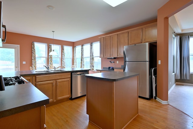 24316 W Bristol Ave, Plainfield, IL 60585 - kitchen featuring stainless steel appliances, dark countertops, a sink, light wood finished floors, and a center island