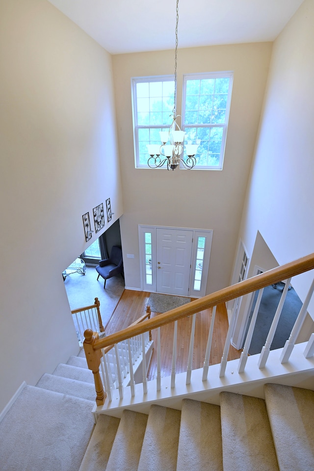 24316 W Bristol Ave, Plainfield, IL 60585 - foyer with stairs, a towering ceiling, a chandelier, and wood finished floors
