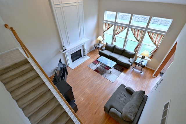 24316 W Bristol Ave, Plainfield, IL 60585 - living room featuring a tiled fireplace, wood finished floors, and baseboards