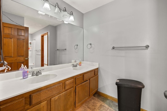 57 Huntcliff Ct, Fox River Grove, IL 60021 - bathroom with baseboards, double vanity, and stone finish flooring