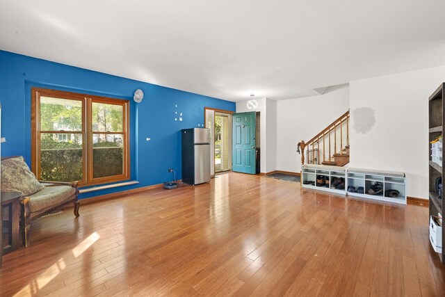 57 Huntcliff Ct, Fox River Grove, IL 60021 - unfurnished living room with stairway, hardwood / wood-style flooring, and baseboards