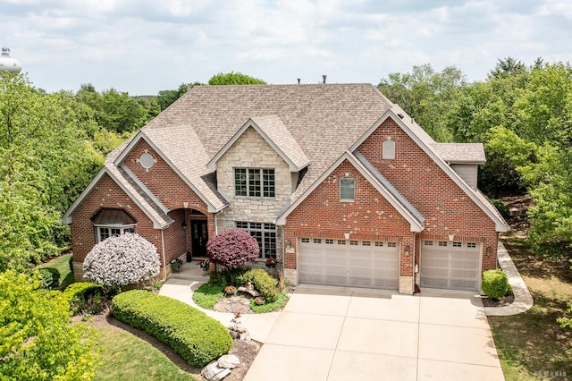 21359 Saddle Ln, Mokena, IL 60448 - view of front of home with driveway, stone siding, a shingled roof, brick siding, and a garage