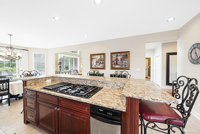 21359 Saddle Ln, Mokena, IL 60448 - kitchen with black gas cooktop, a breakfast bar, a chandelier, healthy amount of natural light, and recessed lighting