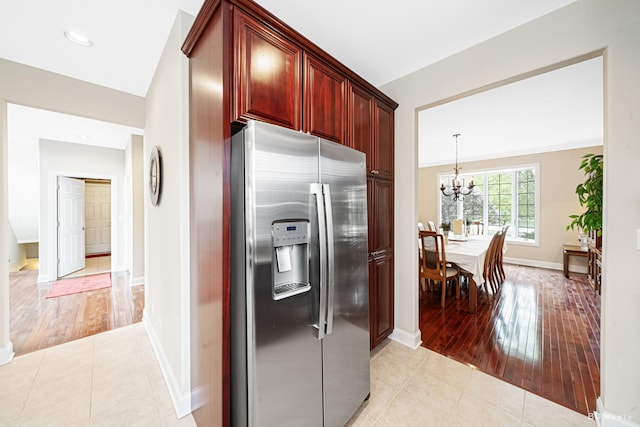 21359 Saddle Ln, Mokena, IL 60448 - kitchen featuring stainless steel fridge, dark brown cabinets, a chandelier, and light wood finished floors