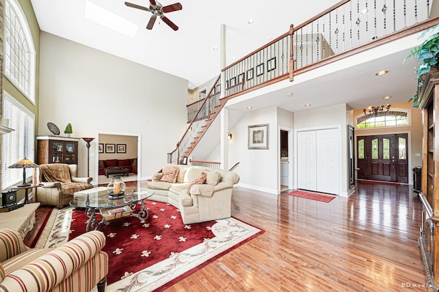 21359 Saddle Ln, Mokena, IL 60448 - living room featuring a high ceiling, a ceiling fan, hardwood / wood-style flooring, baseboards, and stairway
