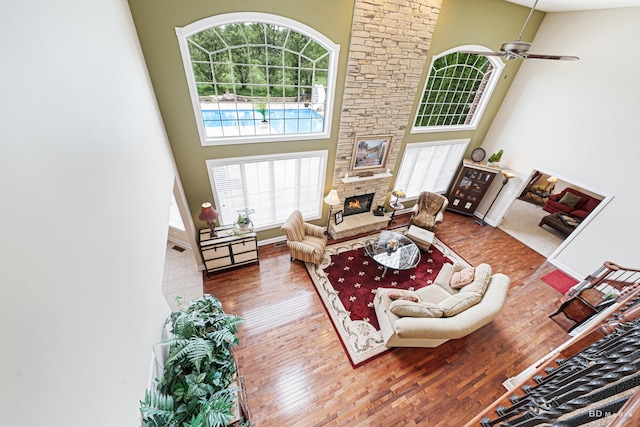 21359 Saddle Ln, Mokena, IL 60448 - living room with a towering ceiling, a stone fireplace, wood finished floors, and a ceiling fan