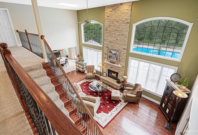 21359 Saddle Ln, Mokena, IL 60448 - living room featuring plenty of natural light, a high ceiling, a fireplace, and ceiling fan