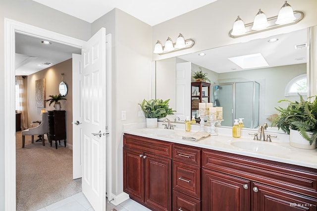 21359 Saddle Ln, Mokena, IL 60448 - bathroom with a skylight, a shower stall, double vanity, tile patterned flooring, and baseboards