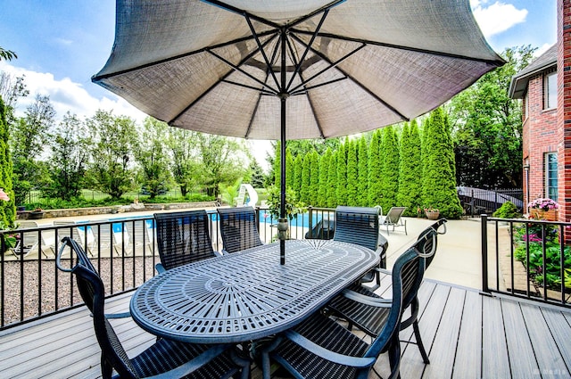 21359 Saddle Ln, Mokena, IL 60448 - deck with outdoor dining space, fence, and view of wooded area