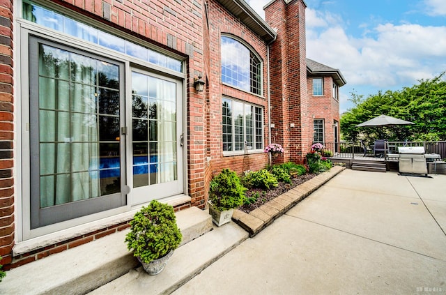 21359 Saddle Ln, Mokena, IL 60448 - property entrance featuring brick siding, outdoor dining area, a chimney, and a patio
