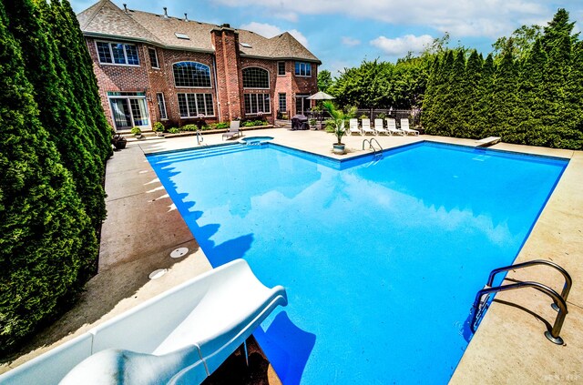 21359 Saddle Ln, Mokena, IL 60448 - view of swimming pool with a patio area, fence, and a diving board