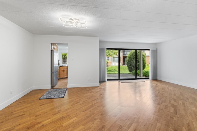 13206 N Country Club Ct Unit 1A, Palos Heights, IL 60463 - unfurnished room featuring plenty of natural light, light wood-style flooring, and baseboards