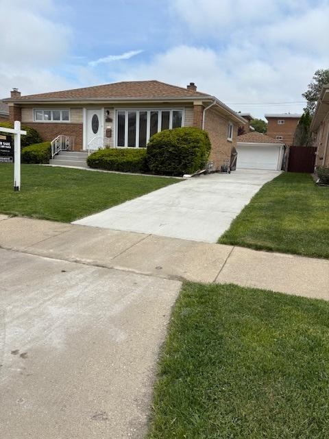 4607 Kolze Ave, Schiller Park, IL 60176 - view of front of home featuring a front lawn, brick siding, and a chimney