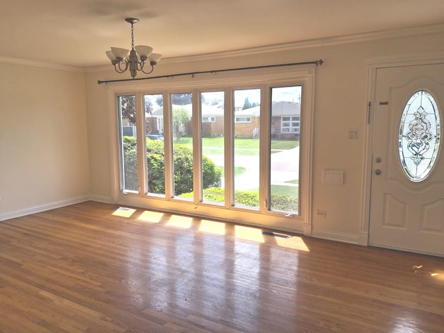 4607 Kolze Ave, Schiller Park, IL 60176 - foyer featuring a chandelier, healthy amount of natural light, baseboards, and crown molding