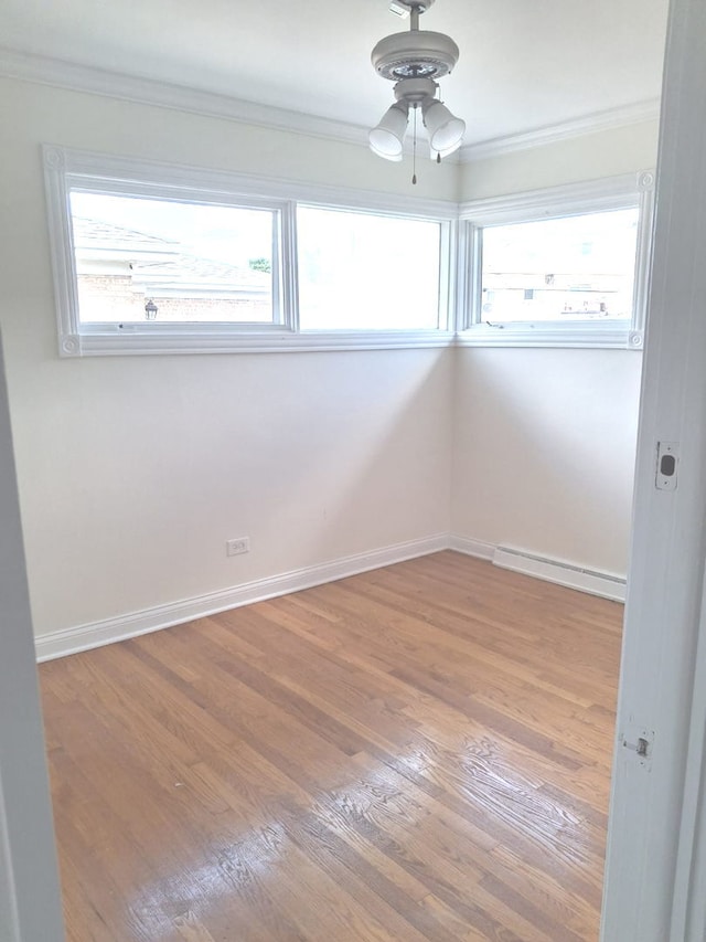 4607 Kolze Ave, Schiller Park, IL 60176 - unfurnished room with ornamental molding, wood finished floors, healthy amount of natural light, baseboards, and a ceiling fan