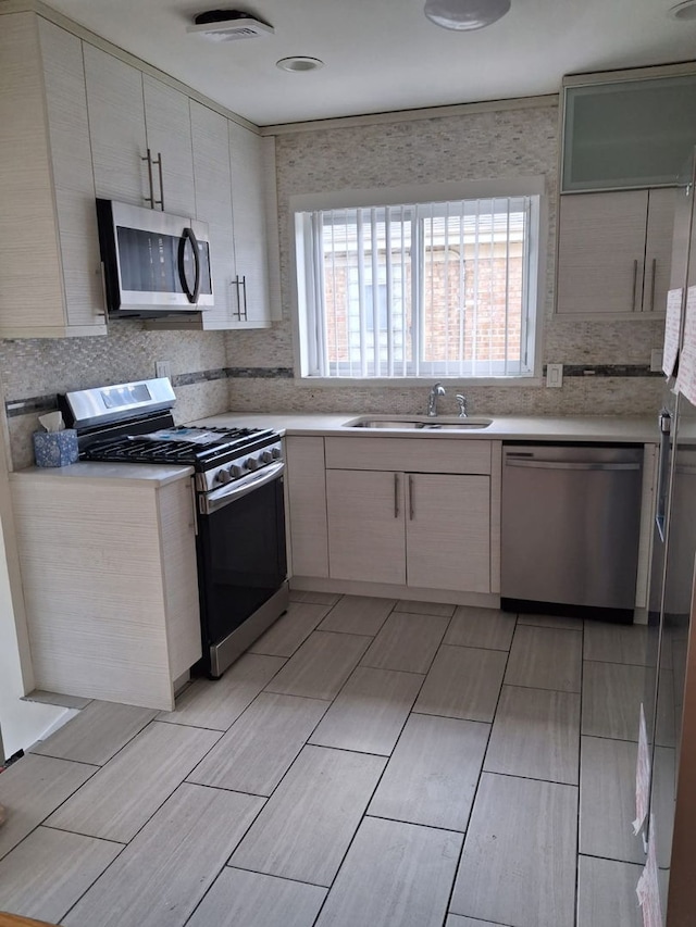 4607 Kolze Ave, Schiller Park, IL 60176 - kitchen featuring stainless steel appliances, a sink, light countertops, and wood finish floors